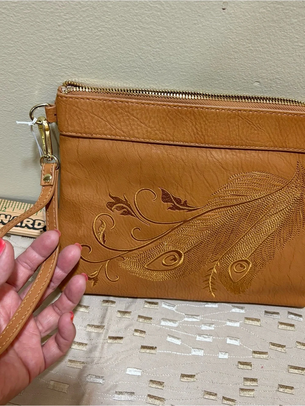 Charming Charlie Tan Wristlet Clutch with Embossed Feather Motif